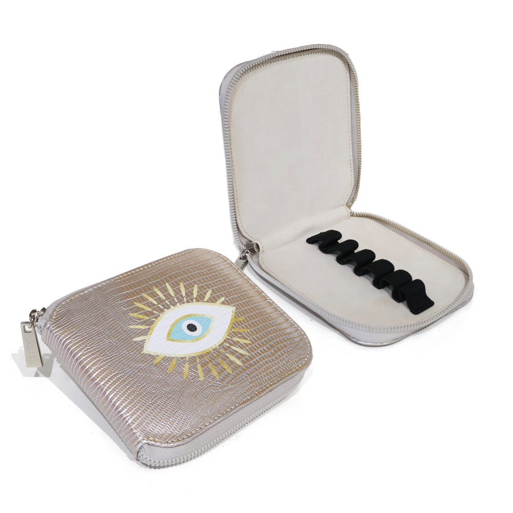 PORTA ACEITES DE VIAJE TEJUS PLATA BEIGE OJO DORADO